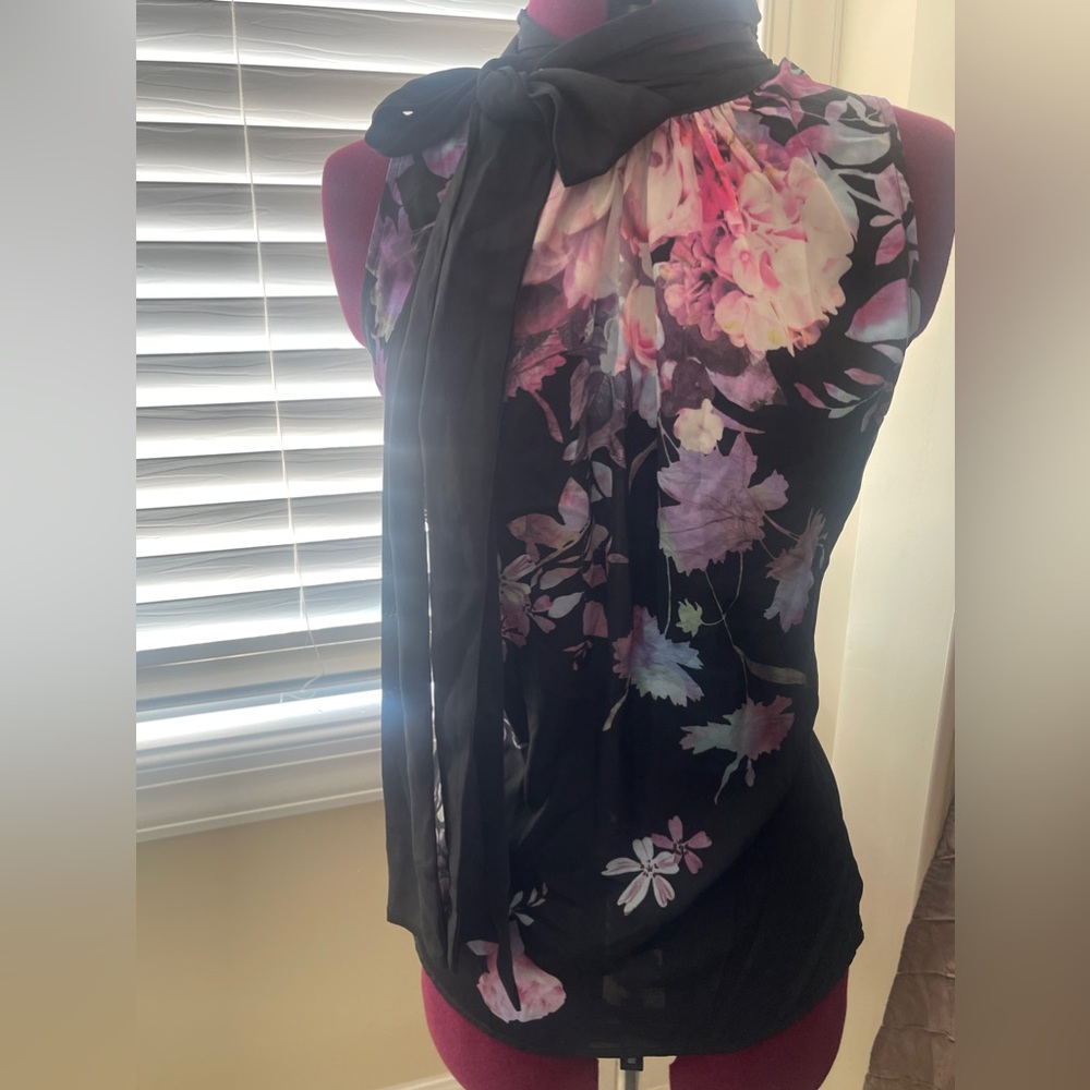 Gently used. Floral sleeveless blouse with neck tie.